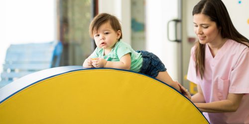 Good looking baby crawling and doing some climbing in an early stimulation school